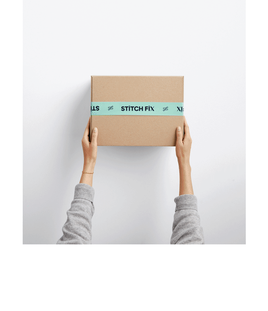 Model holding Stitch Fix subscription box.