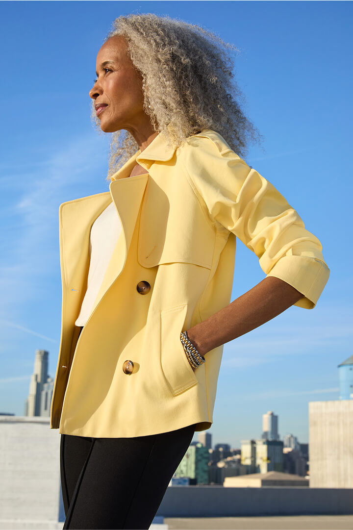 woman in workwear outfit for spring featuring layers including trench coat