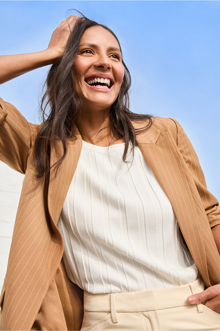 woman wearing spring workwear outfit featuring knit top