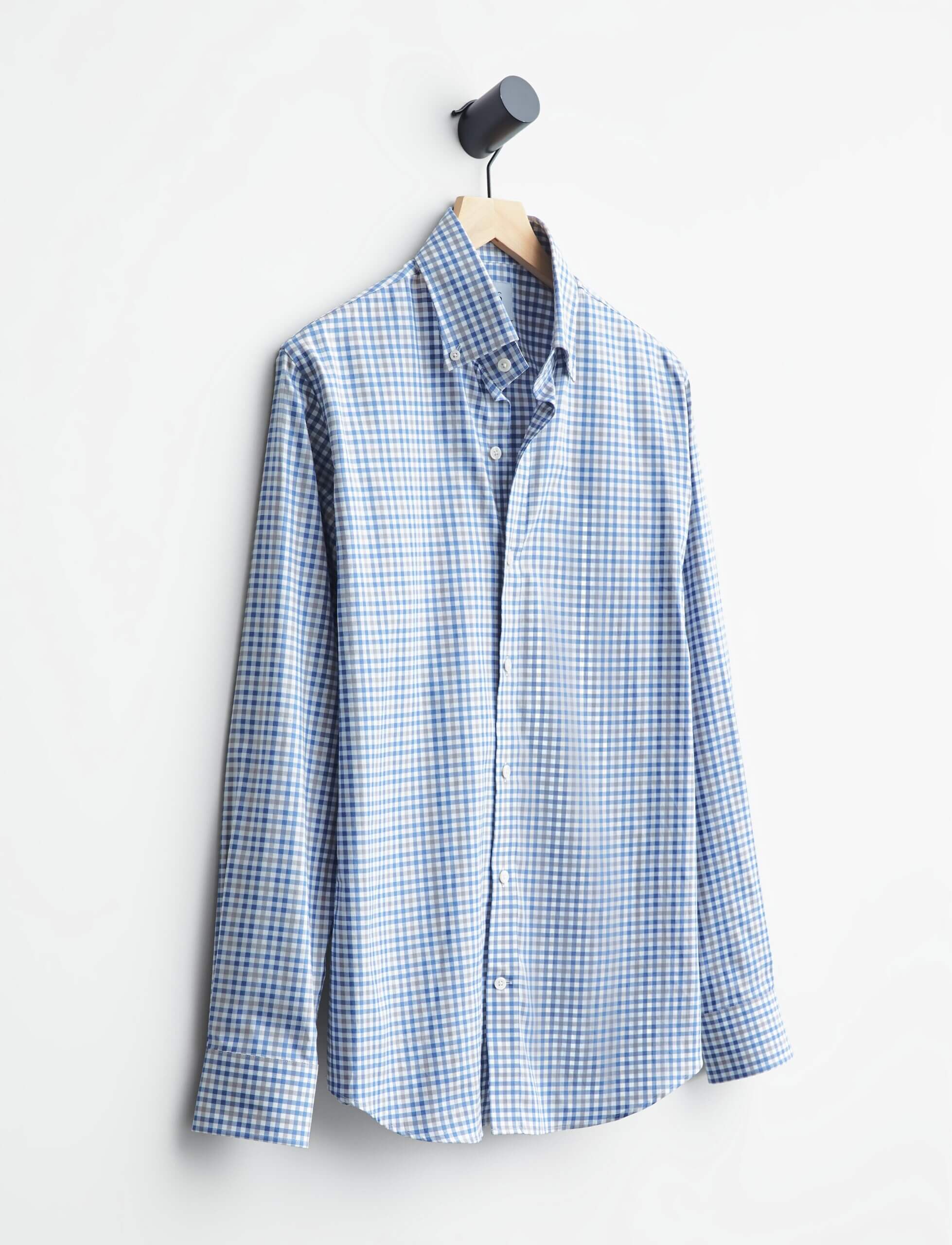 Stitch Fix men’s plaid blue and white button-up hanging on a wood hanger.