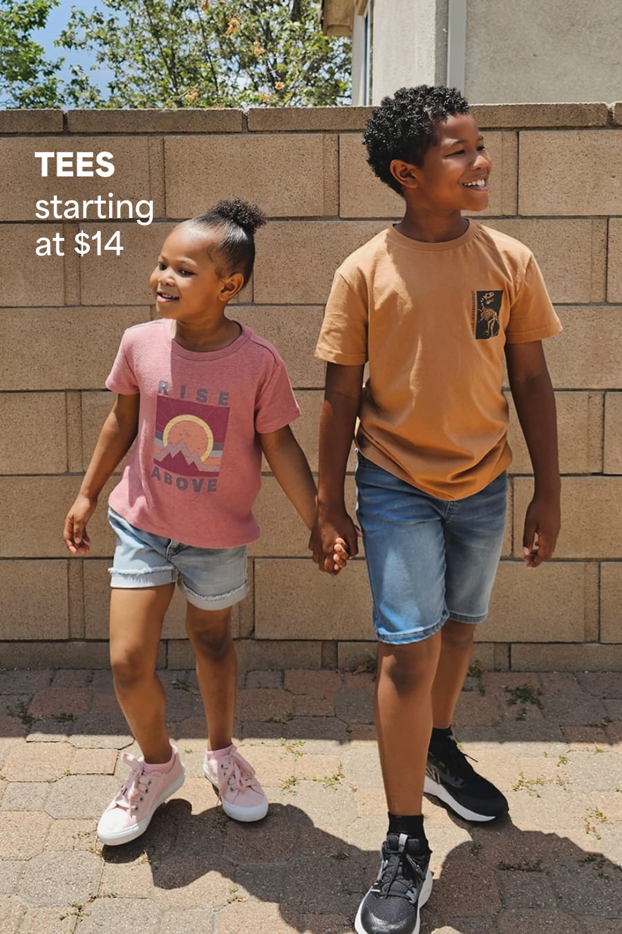 Models wearing Stitch Fix kids clothes including graphic tees, jean shorts and sneakers. Text reads TEES starting at $14.