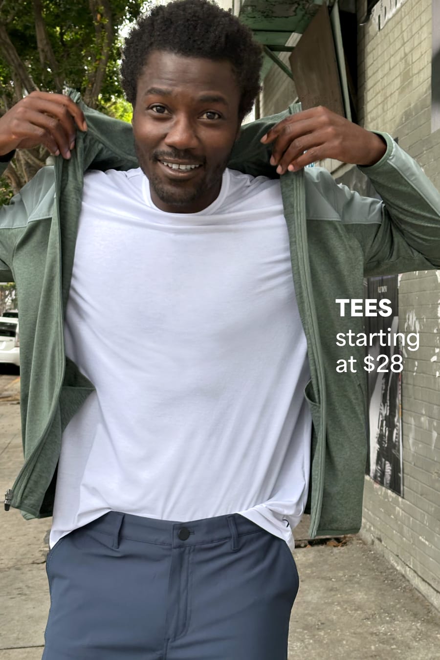 Model wearing Stitch Fix men’s clothes including green hoodie and white tee. Text reads: Tees starting at $28.