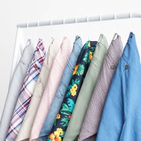 Shorts in various colors hanging on a rack.